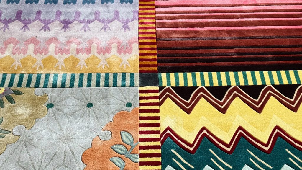 A closeup image of an bamboo silk rug with four unique patterns.