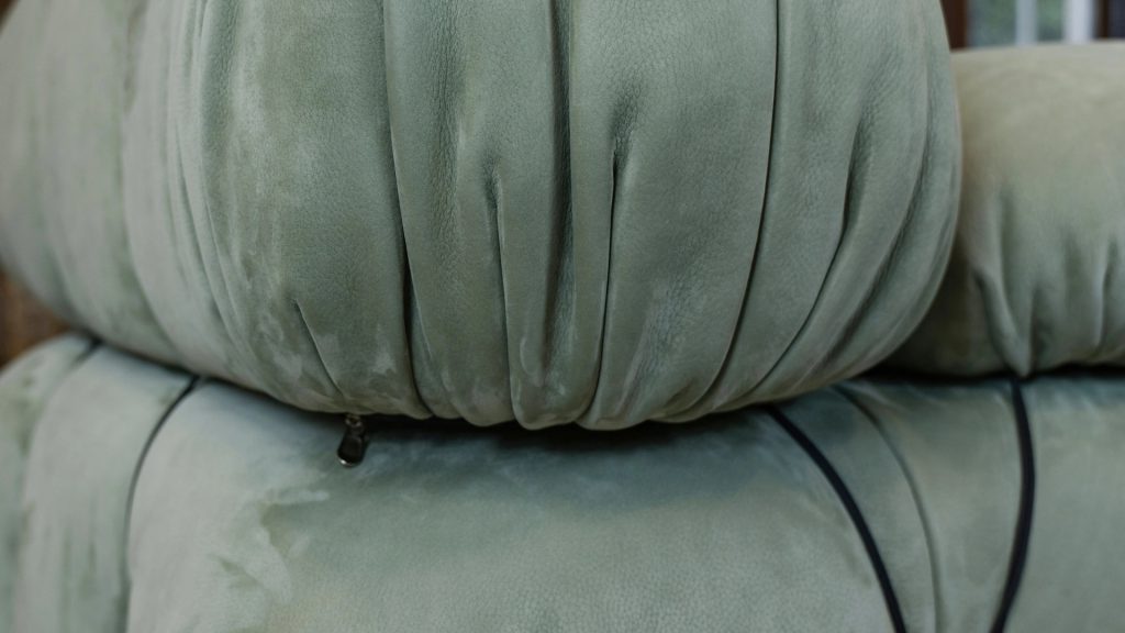 Closeup of a green leather upholstery for a modular sofa.