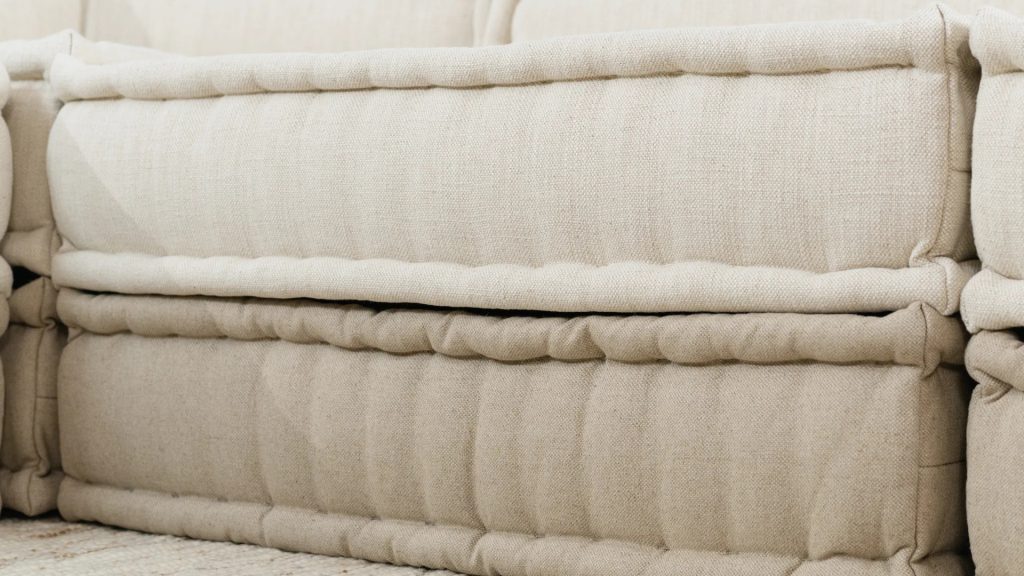Closeup of different palettes of beige linen fabrics for a modular sofa.