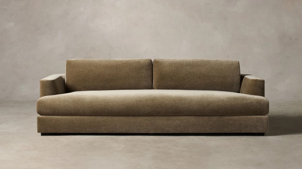 Maiden Home's green sectional in a living room.