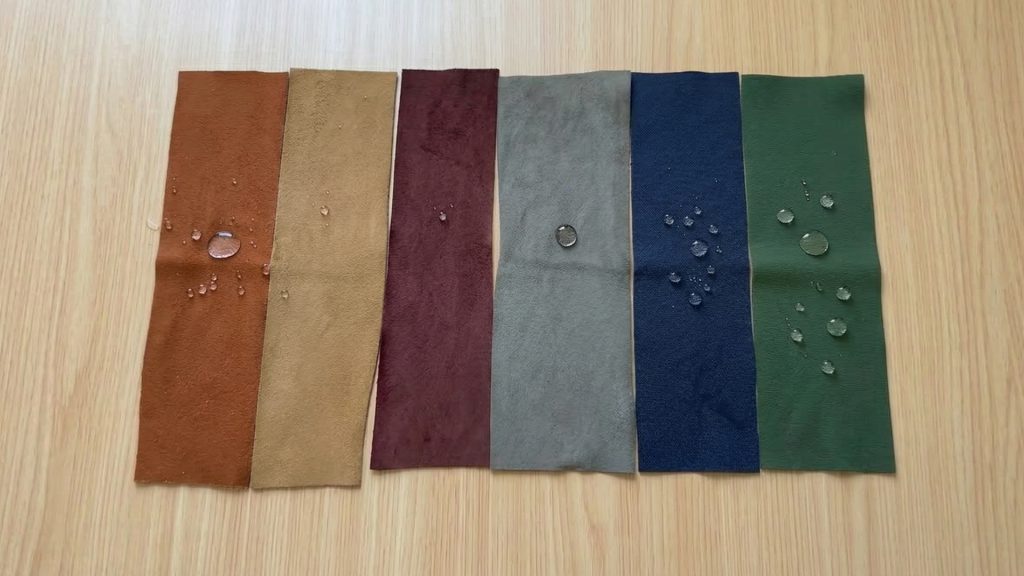 Six performance fabric swatches with water droplets on them.