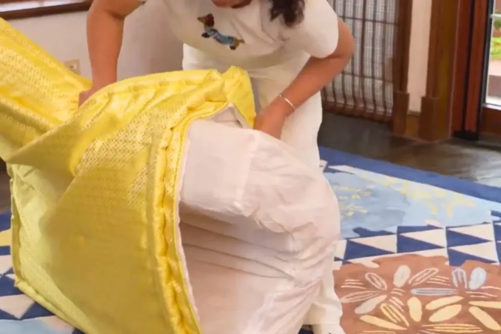 Woman removing a yellow fabric cover from a custom modular sofa cushion