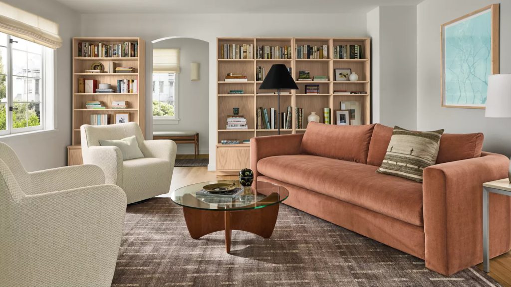 Room & Board's light red sectional in a living room.