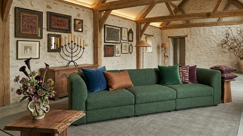 A 3-seater sectional in dark green in a cozy attic.