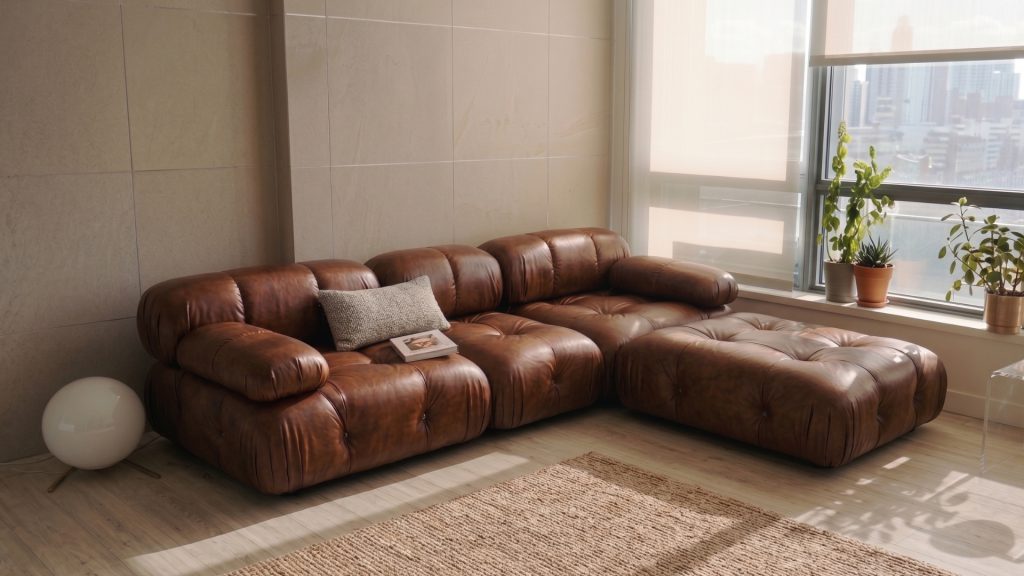 Adorn Croft's Camaleonada sofa in brown leather next to a window.