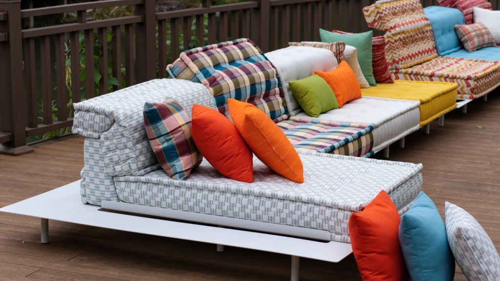 Adorn Croft's colorful outdoor sectional with a metal platform and multicolor upholstered cushions.
