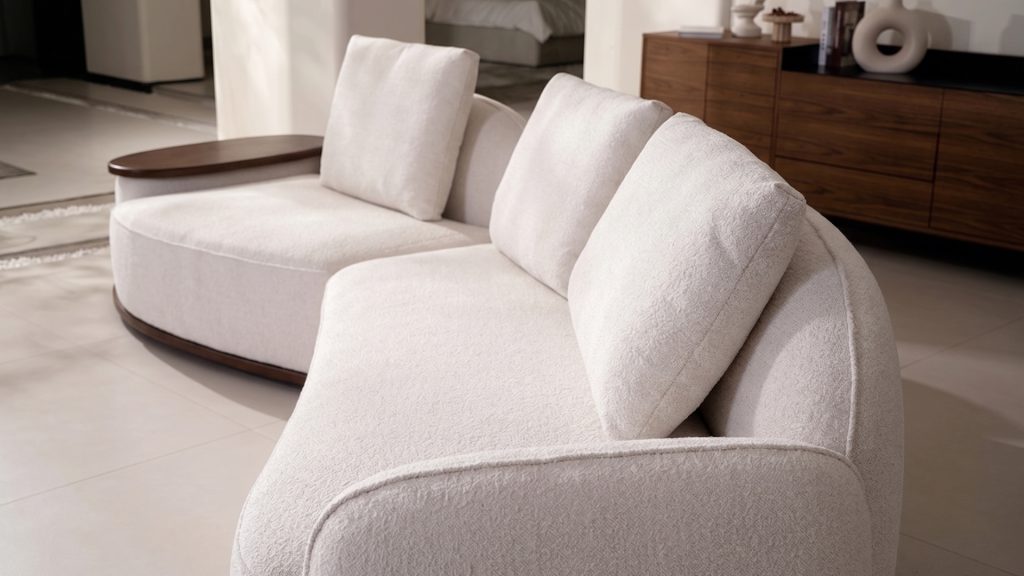Side view of Elara curved sectional, highlighting it's deep seats and tall backrest.