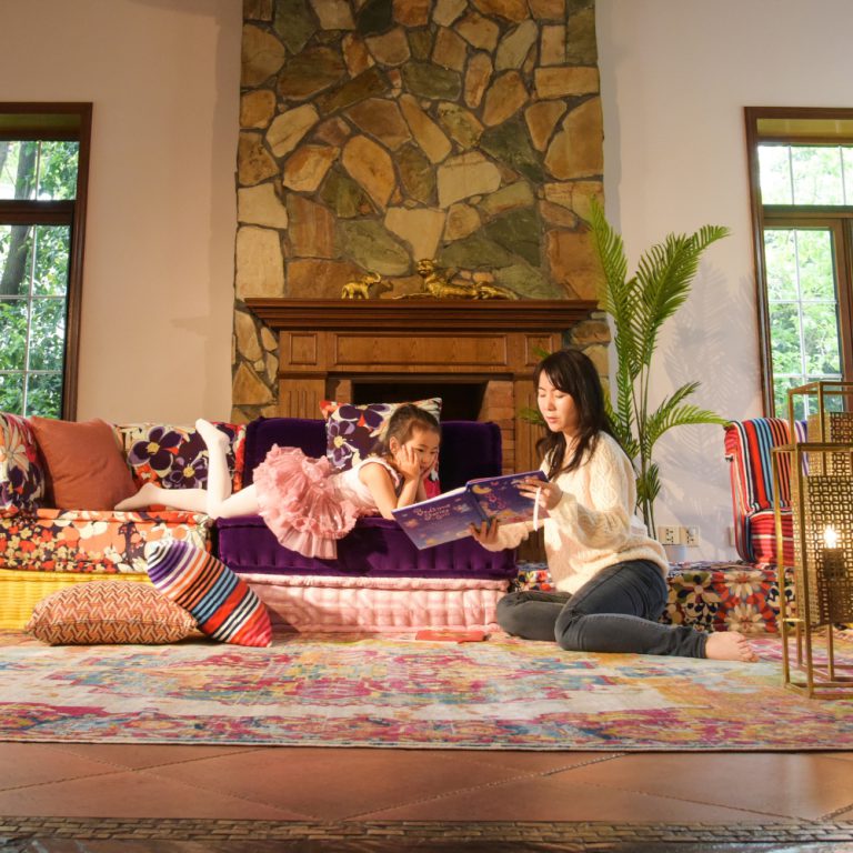 Mom and daughter lounging in a family living room.