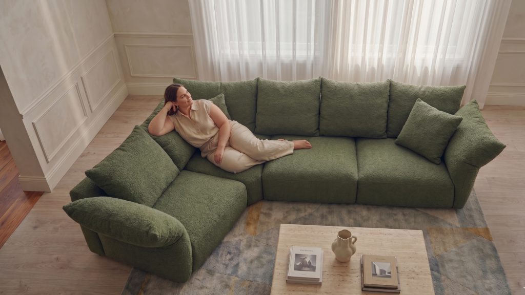 Heavy woman on Adorn Croft's green Petal Sofa with deep seats