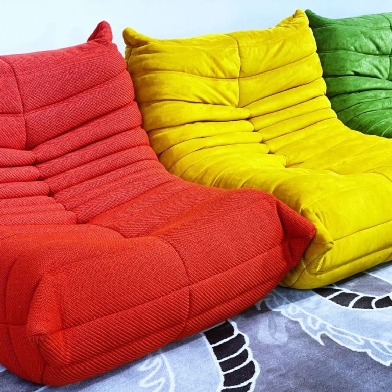 Multicolored Togo sofas in red, yellow, and green.