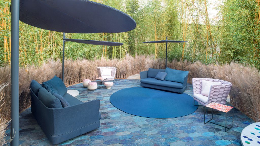 Paola Lenti's Cove modular outdoor sofas arranged on a stone patio.