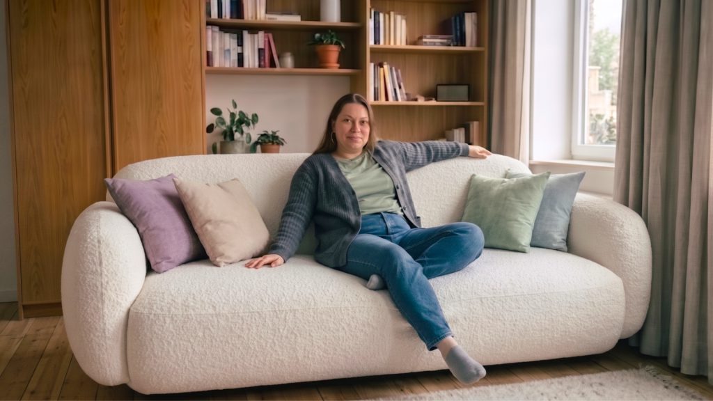 Plus-size woman on a durable rounded white sofa with colorful throw pillows.