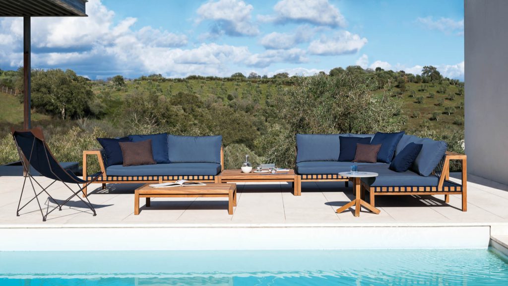 RODA's Network outdoor sofas featuring teak wood frames and blue upholstery.