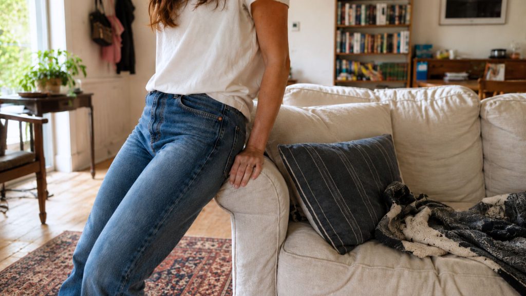 Woman doing the hip test on a sofa