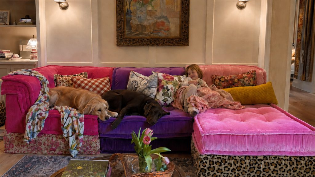 A child and two dogs sitting on the Adorn Croft Esther Colorful Sofa in a family living room