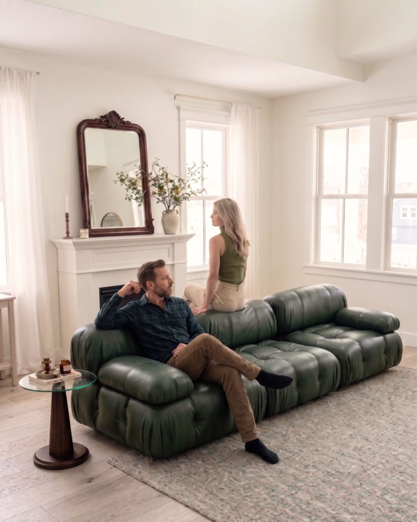 Couple relaxing on a deep green organic leather Mario Bellini modular sofa in a bright living room