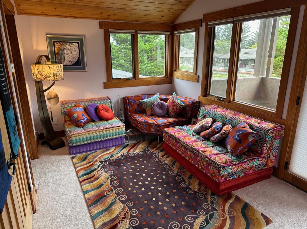 Large Mah Jong sectional in mixed fabrics including red checkered, pink velvet, corduroy, and bold printed patterns