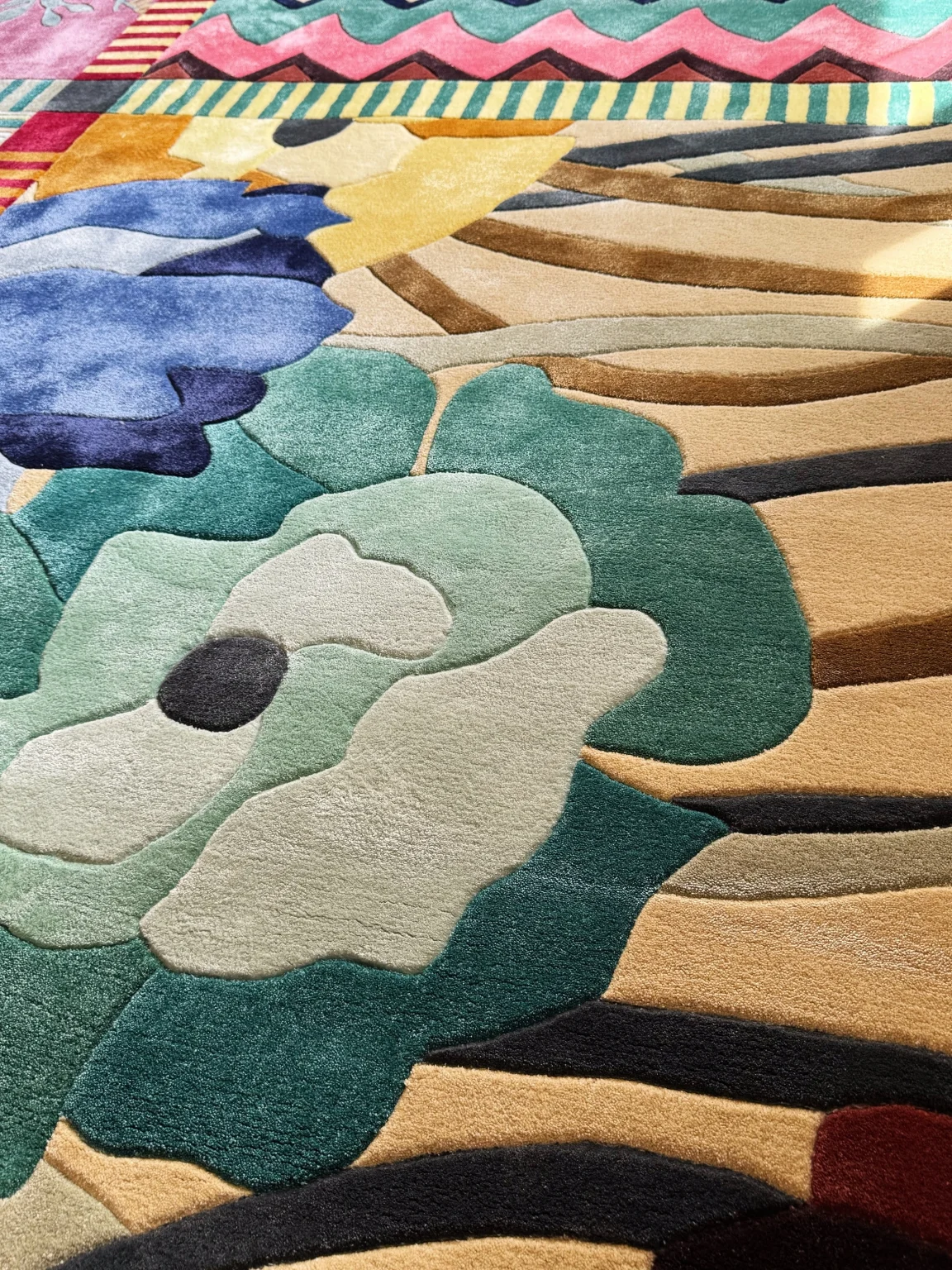 Close-up of hand-tufted bamboo silk rug showing varied pile height and floral detail