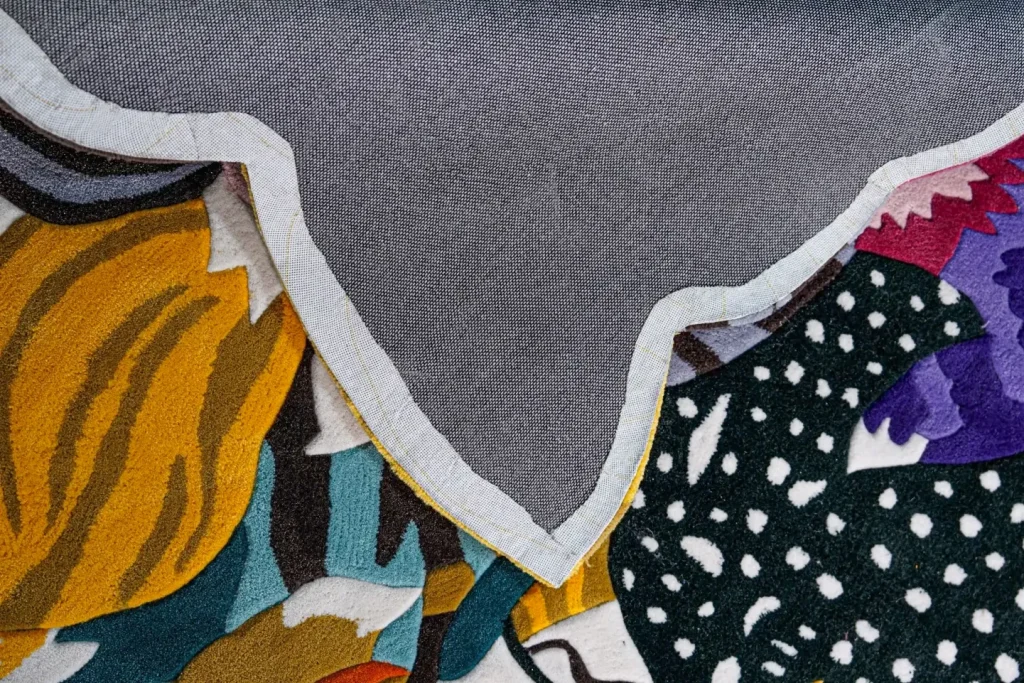 Underside of a hand-tufted rug showing its clean fabric backing