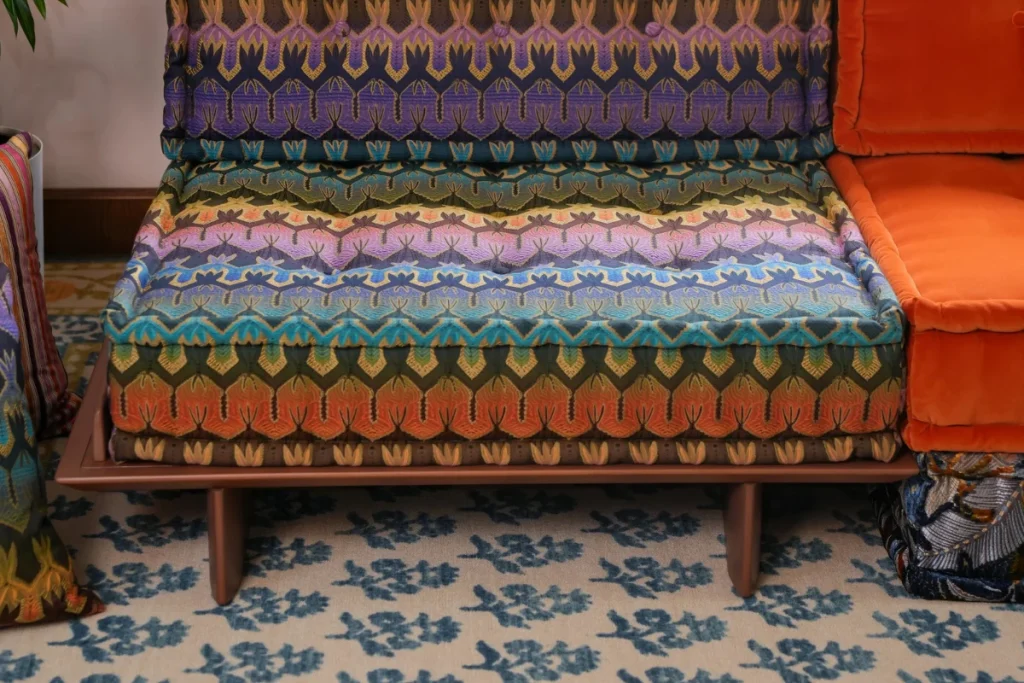 Colorful modular sofa elevated with a wood base