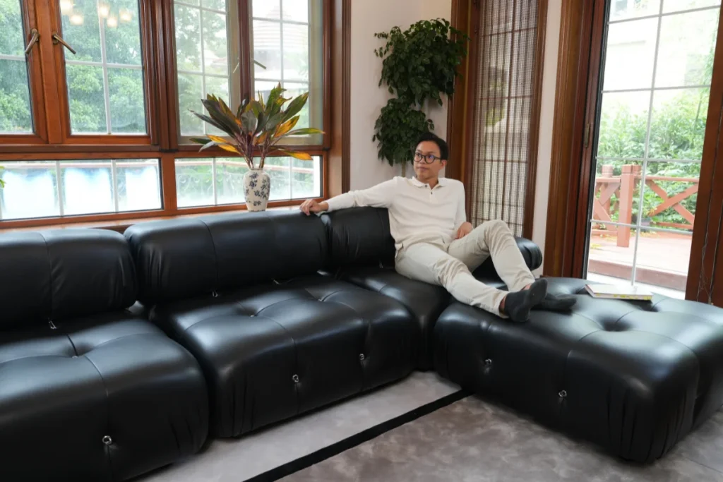 Man lounging on the corner of a Mario Bellini sectional