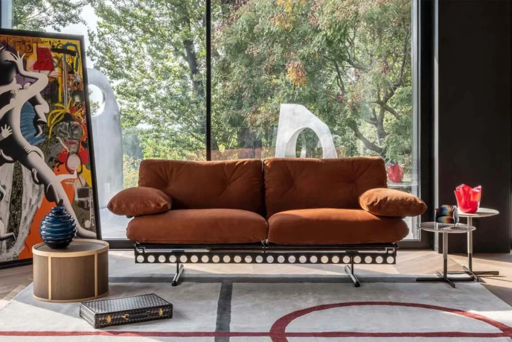Poltrona Frau modular sofa in rust velvet with metal base, styled with art and sculpture